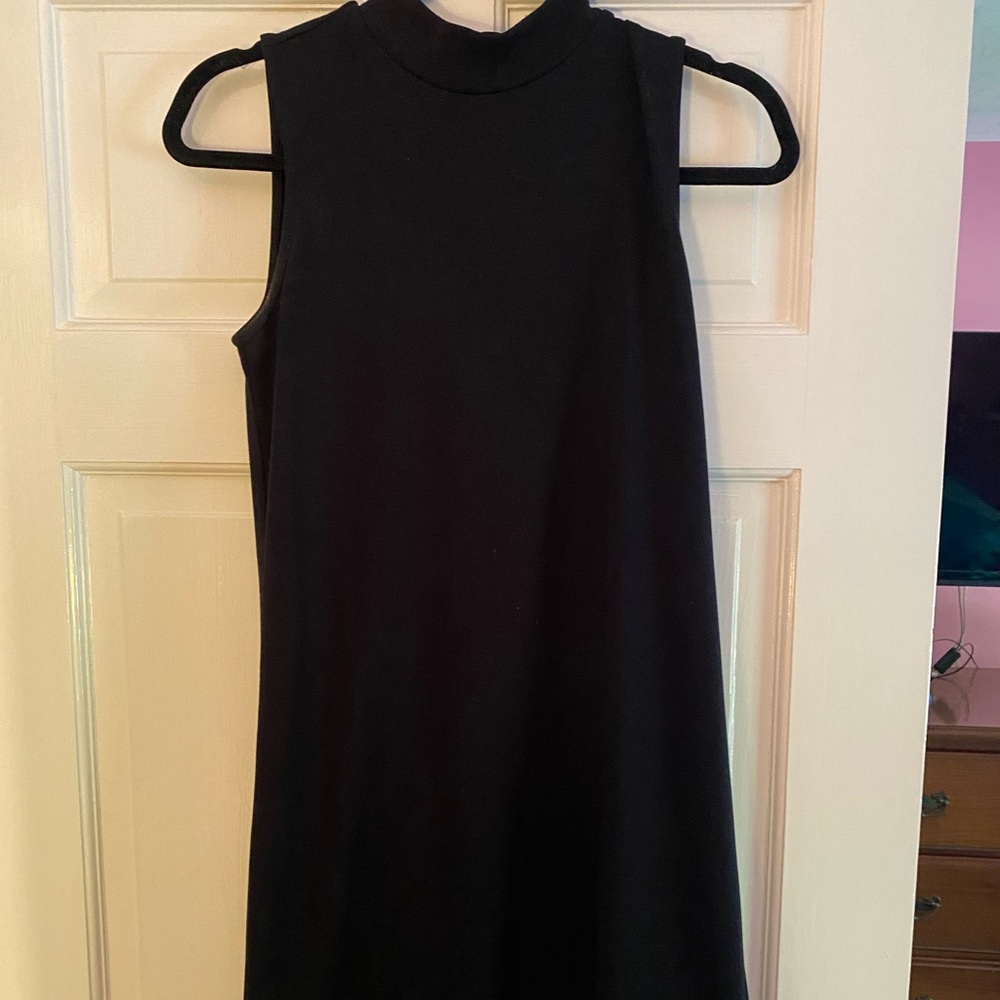 Little black dress. High neck. Zippers on the back.